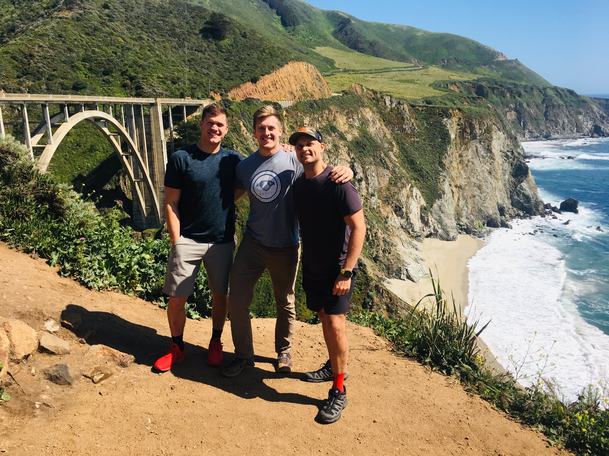 Dr. Ryan Klopfer and his friends on a hike with beautiful scenery in the background